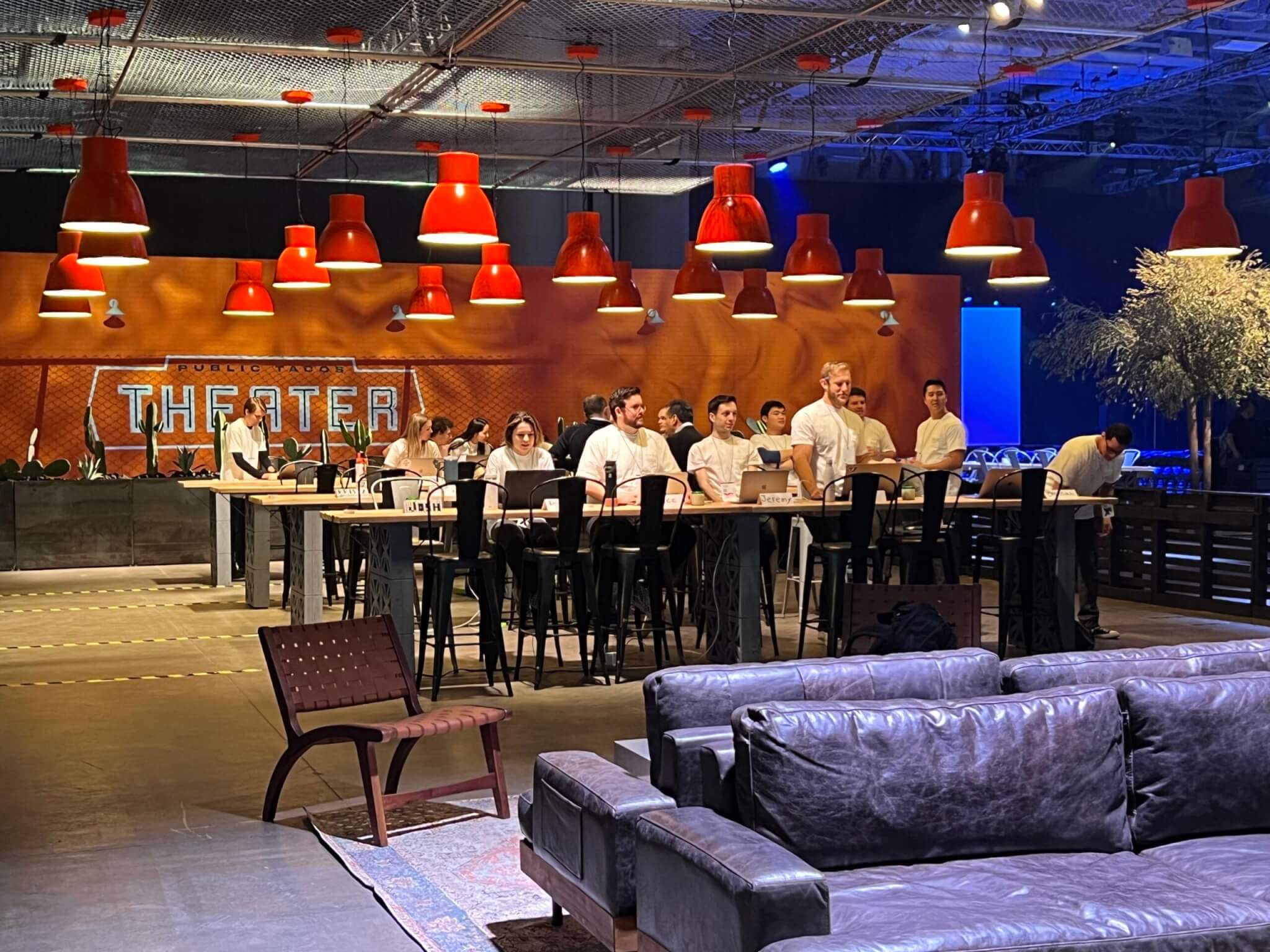 Row of desks against with Qualtrics support staff ready to answer questions at X4.