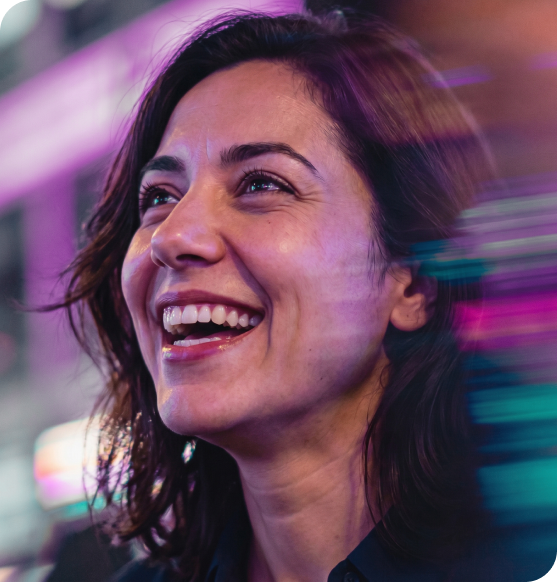 3/4 view of woman smiling looking off into the distance